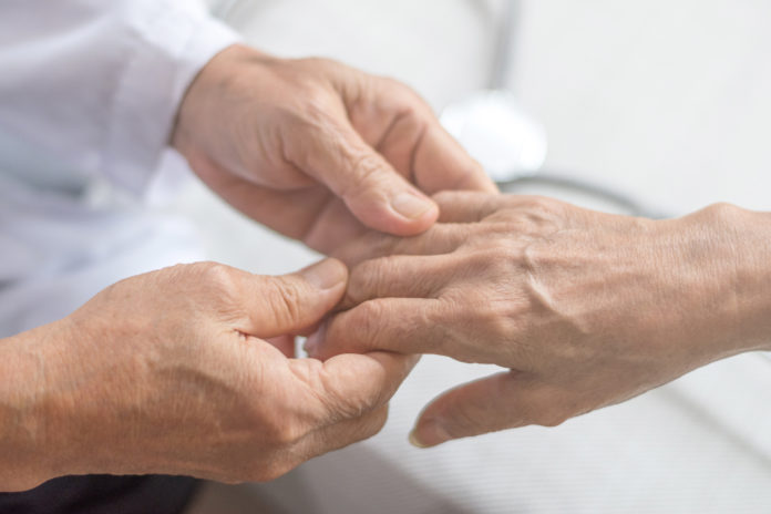 doctor examining patient's hand